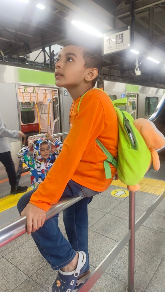 Vihaan at a train station platform during an adventure outing